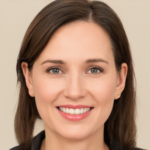 Joyful white young-adult female with long  brown hair and brown eyes