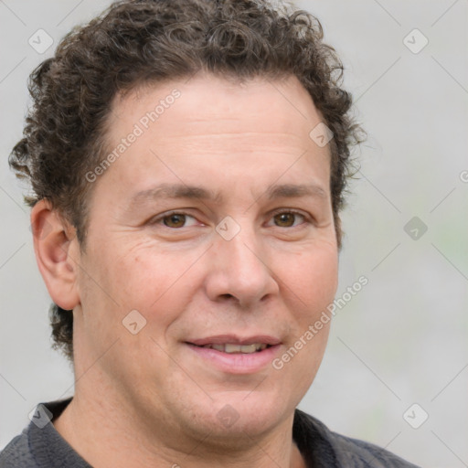 Joyful white adult male with short  brown hair and grey eyes