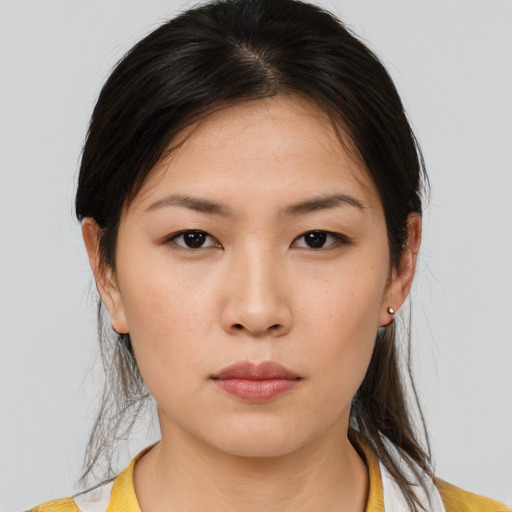Neutral asian young-adult female with medium  brown hair and brown eyes