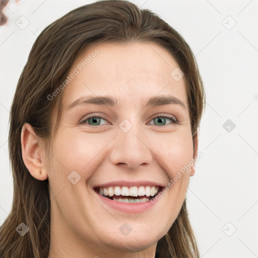 Joyful white young-adult female with long  brown hair and green eyes