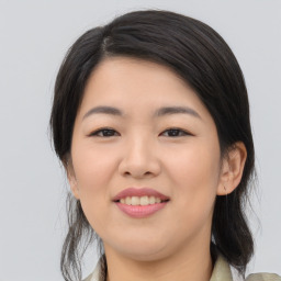 Joyful asian young-adult female with medium  black hair and brown eyes