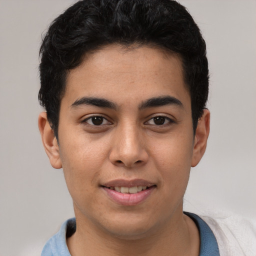Joyful latino young-adult male with short  black hair and brown eyes