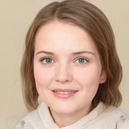 Joyful white young-adult female with medium  brown hair and green eyes