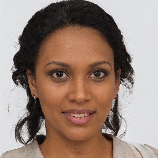 Joyful black young-adult female with medium  brown hair and brown eyes