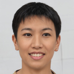 Joyful asian young-adult female with short  black hair and brown eyes