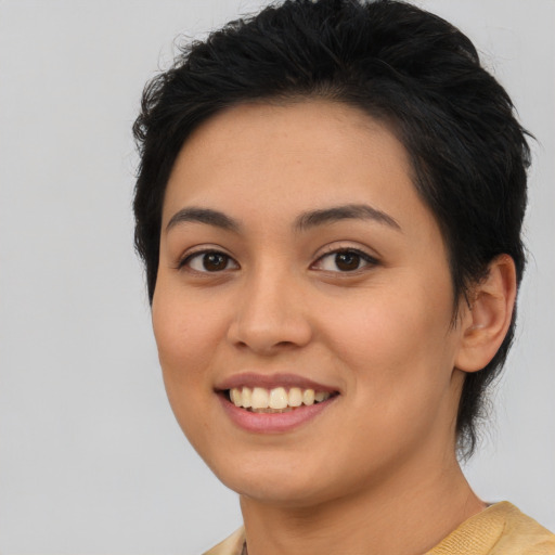 Joyful latino young-adult female with short  brown hair and brown eyes