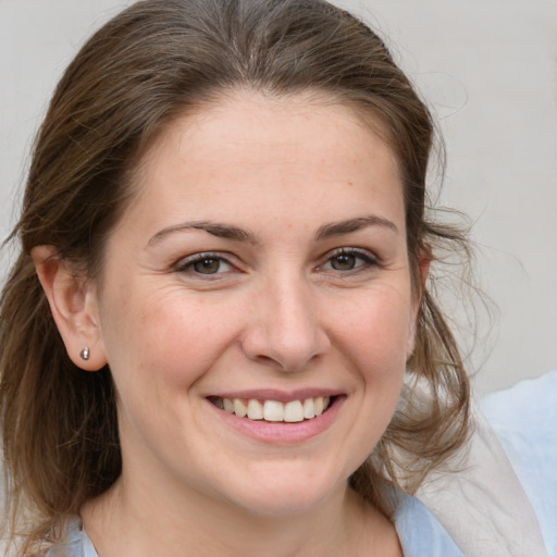 Joyful white adult female with medium  brown hair and grey eyes