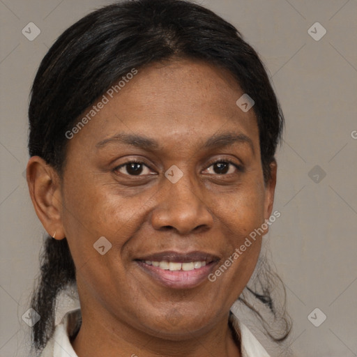 Joyful black adult female with medium  brown hair and brown eyes