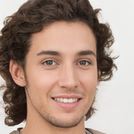 Joyful white young-adult male with medium  brown hair and brown eyes