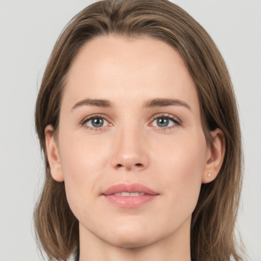 Joyful white young-adult female with medium  brown hair and green eyes