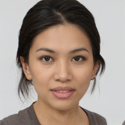 Joyful latino young-adult female with medium  brown hair and brown eyes