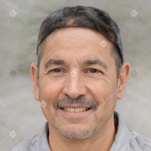 Joyful white adult male with short  black hair and brown eyes