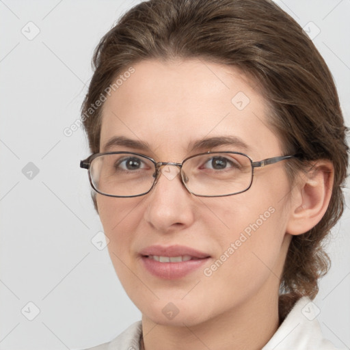 Joyful white adult female with medium  brown hair and grey eyes