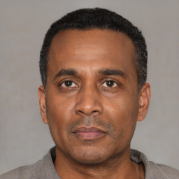 Neutral black adult male with short  black hair and brown eyes