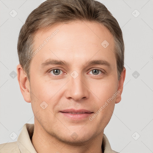 Joyful white young-adult male with short  brown hair and grey eyes