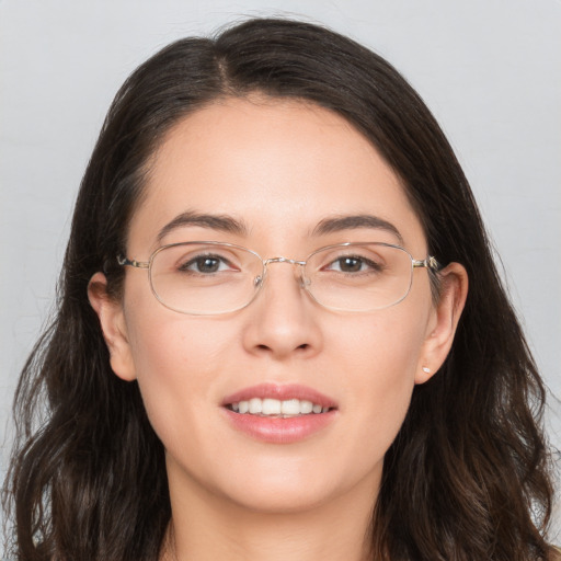 Joyful white adult female with long  brown hair and brown eyes