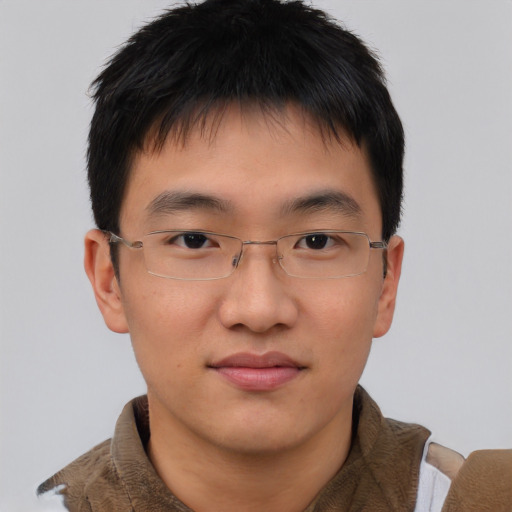 Joyful asian young-adult male with short  brown hair and brown eyes