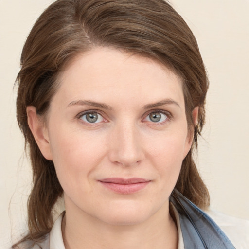 Joyful white young-adult female with medium  brown hair and blue eyes