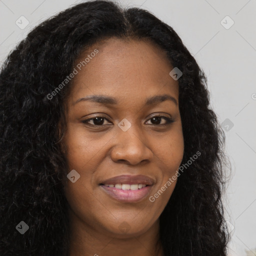 Joyful black young-adult female with long  brown hair and brown eyes