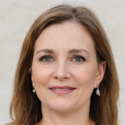 Joyful white adult female with medium  brown hair and grey eyes