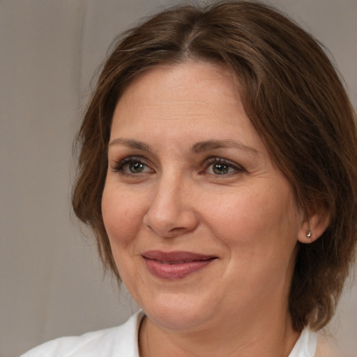 Joyful white adult female with medium  brown hair and brown eyes