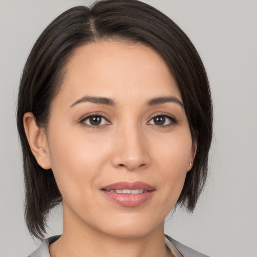 Joyful white young-adult female with medium  brown hair and brown eyes