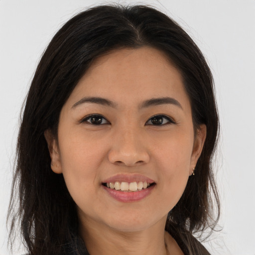 Joyful white young-adult female with long  brown hair and brown eyes