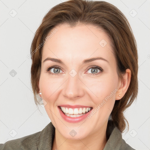 Joyful white adult female with medium  brown hair and grey eyes