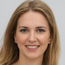 Joyful white young-adult female with long  brown hair and grey eyes