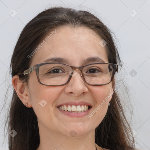 Joyful white adult female with long  brown hair and brown eyes