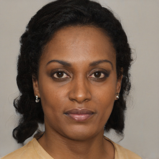 Neutral black young-adult female with medium  brown hair and brown eyes