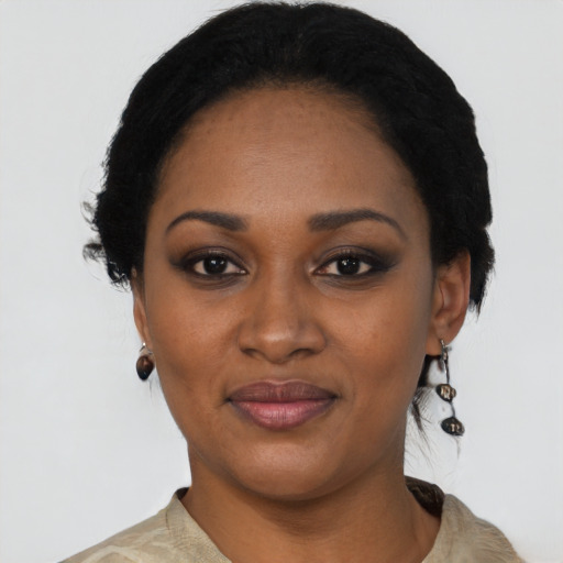 Joyful black young-adult female with short  black hair and brown eyes