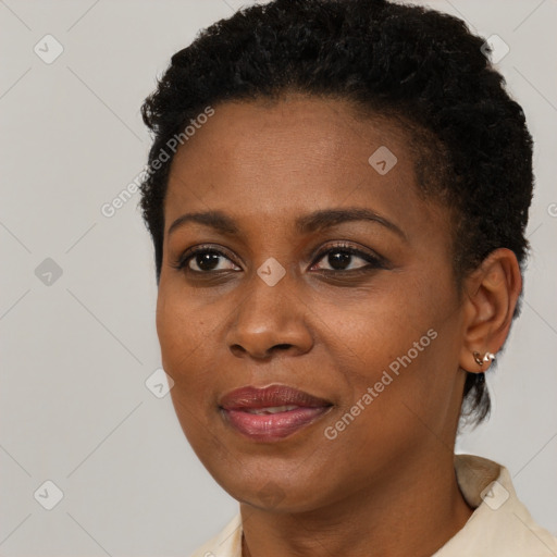 Joyful black young-adult female with short  black hair and brown eyes