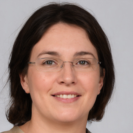 Joyful white adult female with medium  brown hair and brown eyes