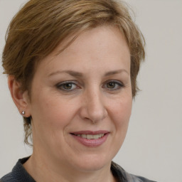 Joyful white adult female with medium  brown hair and grey eyes