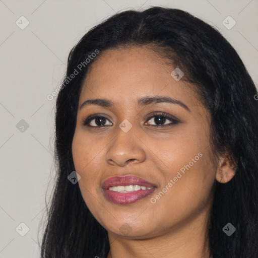 Joyful black young-adult female with long  black hair and brown eyes