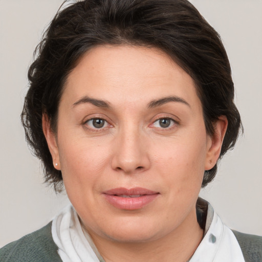 Joyful white adult female with medium  brown hair and brown eyes