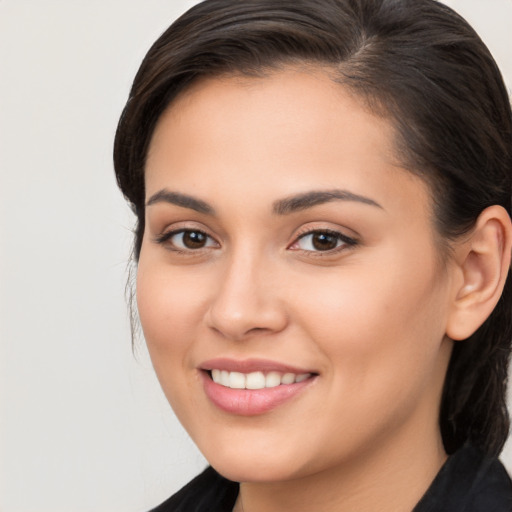 Joyful white young-adult female with long  brown hair and brown eyes