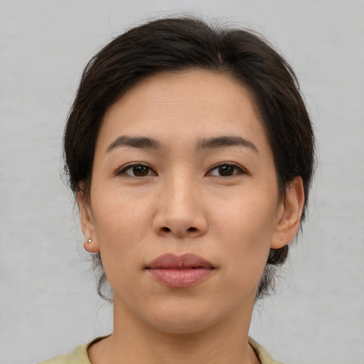 Joyful asian young-adult female with medium  brown hair and brown eyes