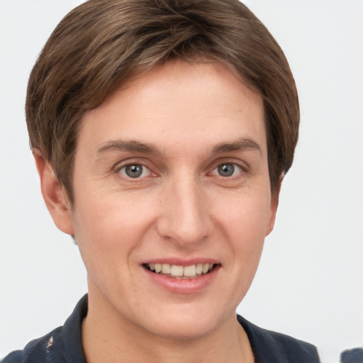 Joyful white young-adult female with short  brown hair and grey eyes