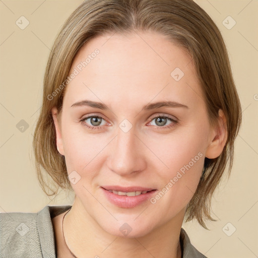 Joyful white young-adult female with medium  brown hair and blue eyes