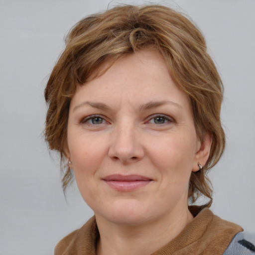 Joyful white young-adult female with medium  brown hair and blue eyes