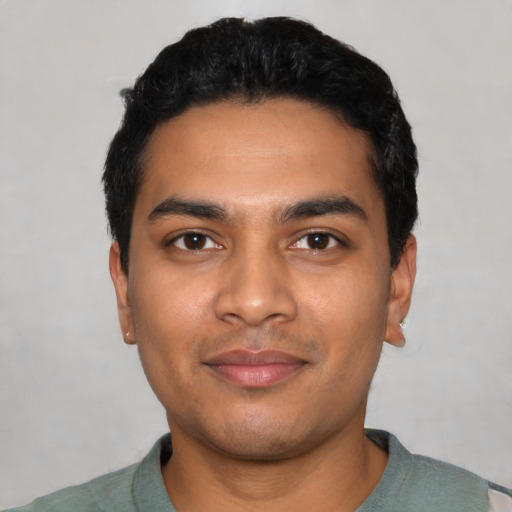 Joyful latino young-adult male with short  black hair and brown eyes