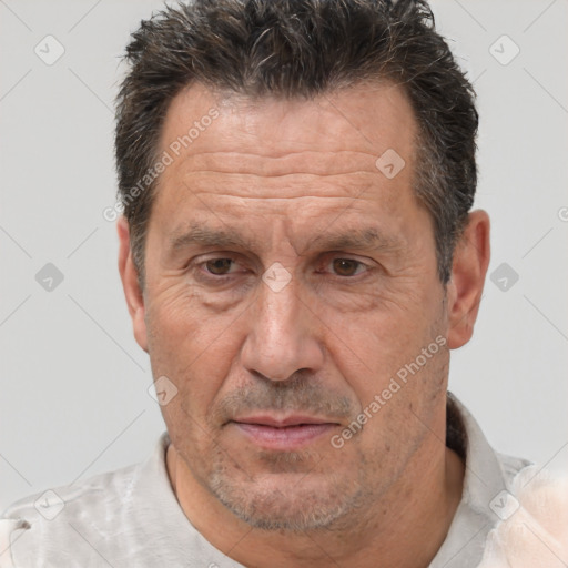 Joyful white middle-aged male with short  brown hair and brown eyes