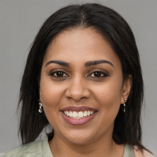 Joyful black young-adult female with medium  brown hair and brown eyes