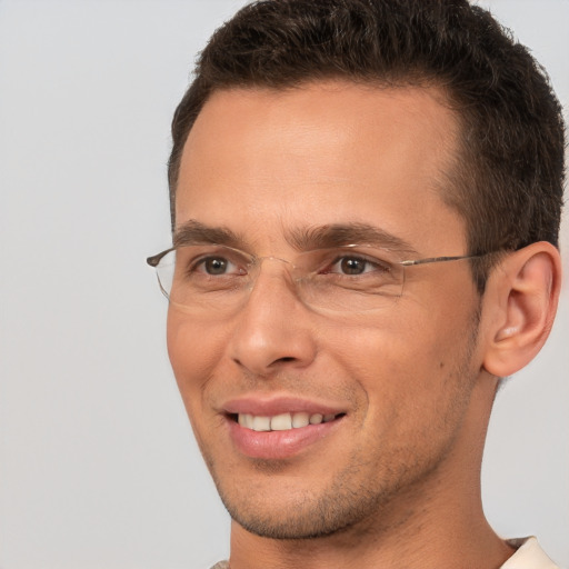 Joyful white young-adult male with short  brown hair and brown eyes