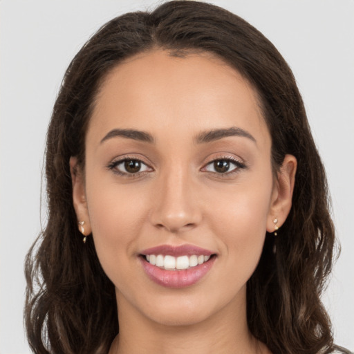 Joyful white young-adult female with long  brown hair and brown eyes