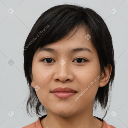 Joyful asian young-adult female with medium  black hair and brown eyes