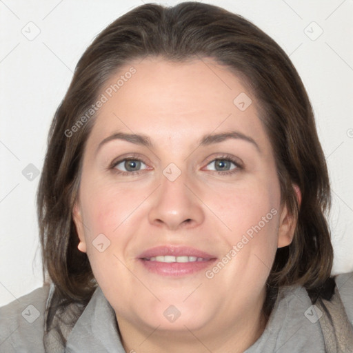 Joyful white adult female with medium  brown hair and blue eyes