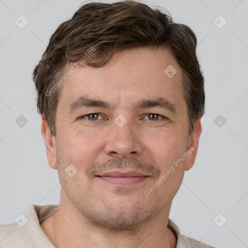 Joyful white adult male with short  brown hair and grey eyes